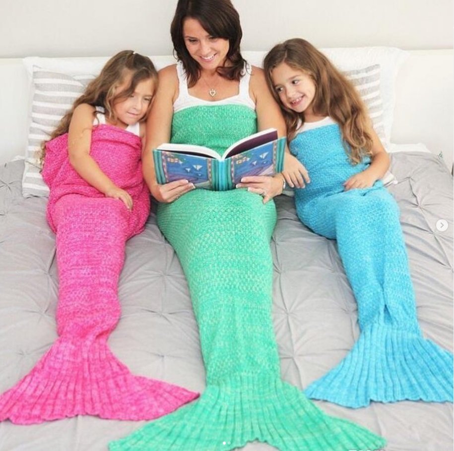 3 people wearing mermaid blankets